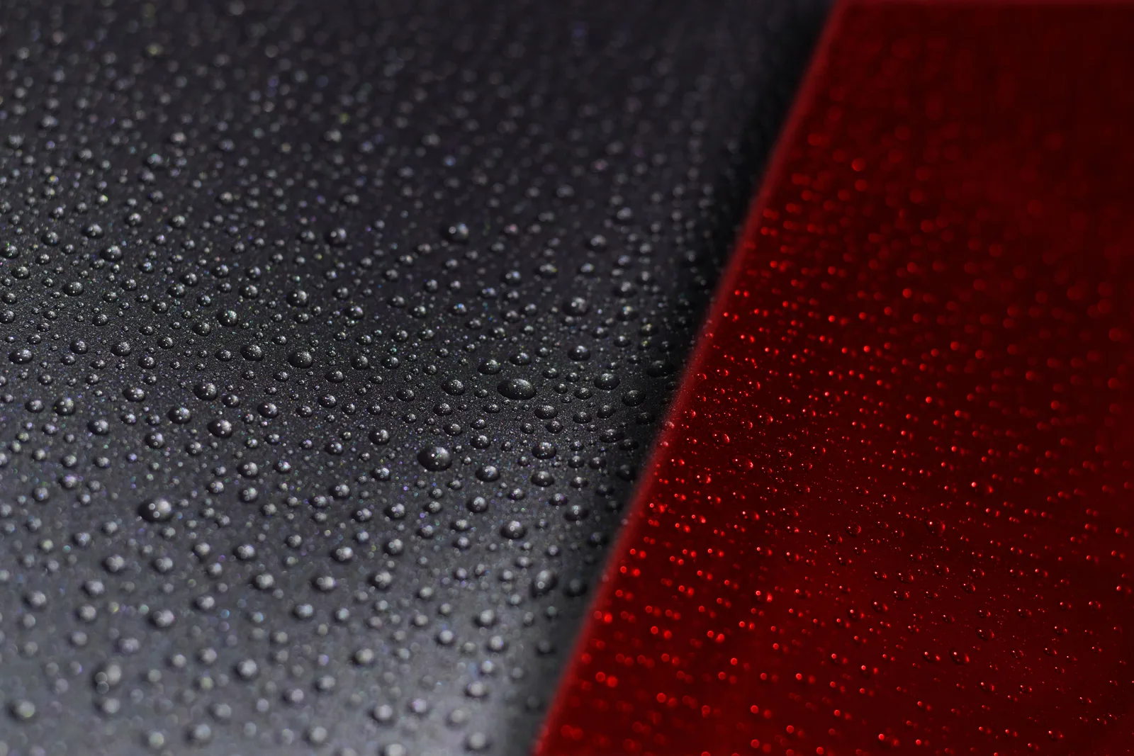 Coated black and red panels under a raking studio light